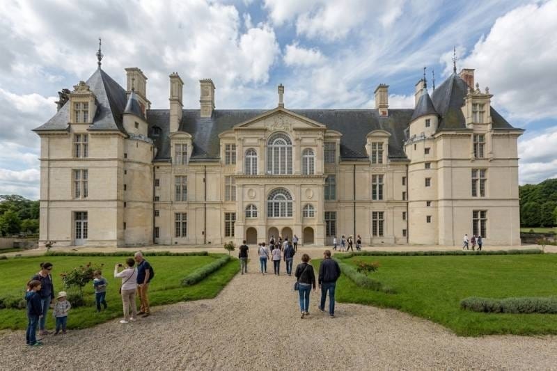 Château d'Écouen Renaissance façade with visitors on the gravel approach