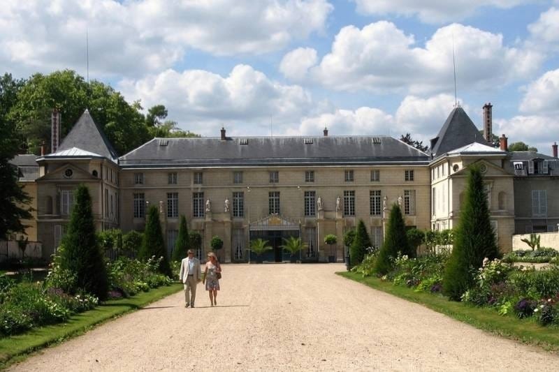 Château de Malmaison seen from the tree-lined entrance drive