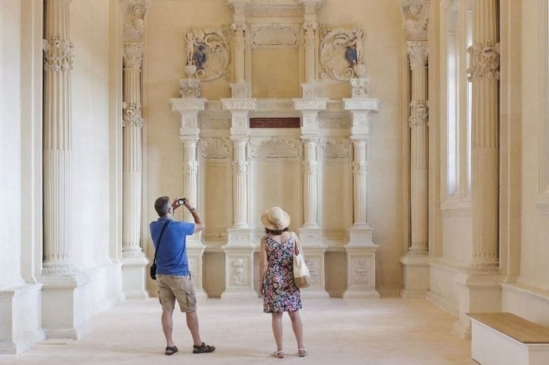 Restored interior gallery of the Château de Villers-Cotterêts with visitors