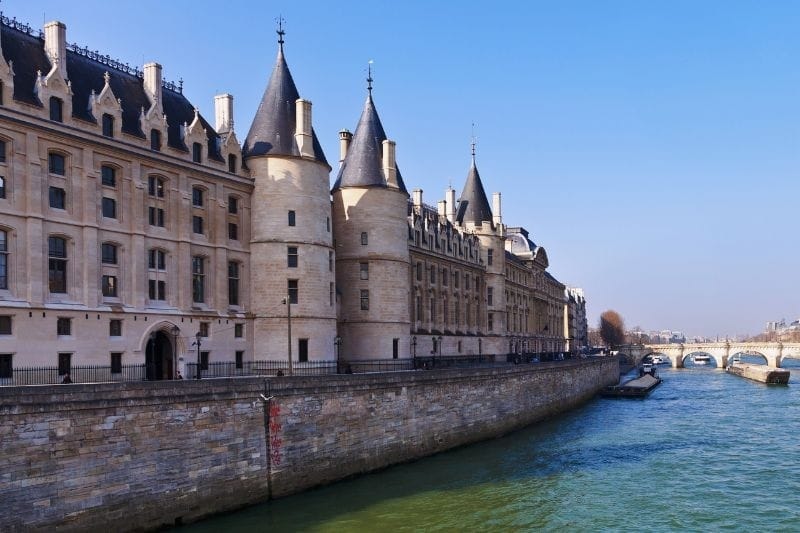 Medieval towers of the Conciergerie rising above the Seine, Paris