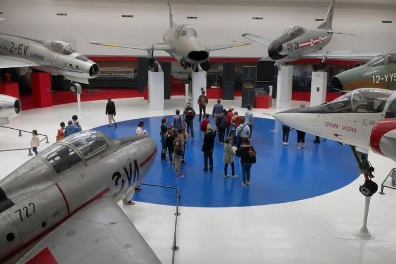 Historic jet fighters suspended in the main hall of the Musée de l'Air et de l'Espace