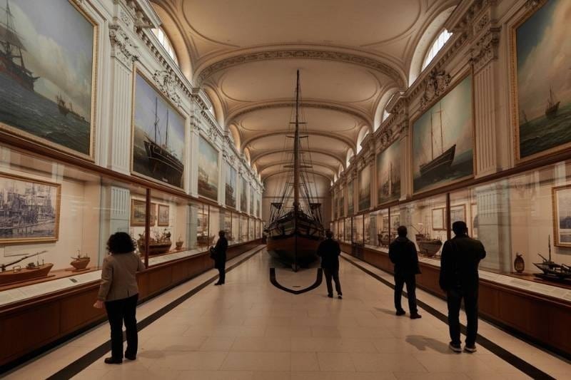 Long gallery of the Musée National de la Marine with ship models and maritime paintings