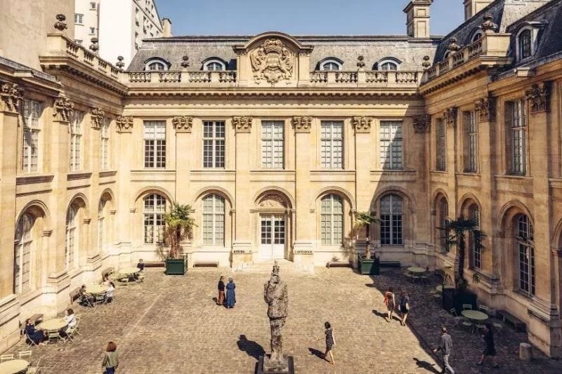 Sunlit cobblestone courtyard of the Musée d'Art et d'Histoire du Judaïsme in the Marais